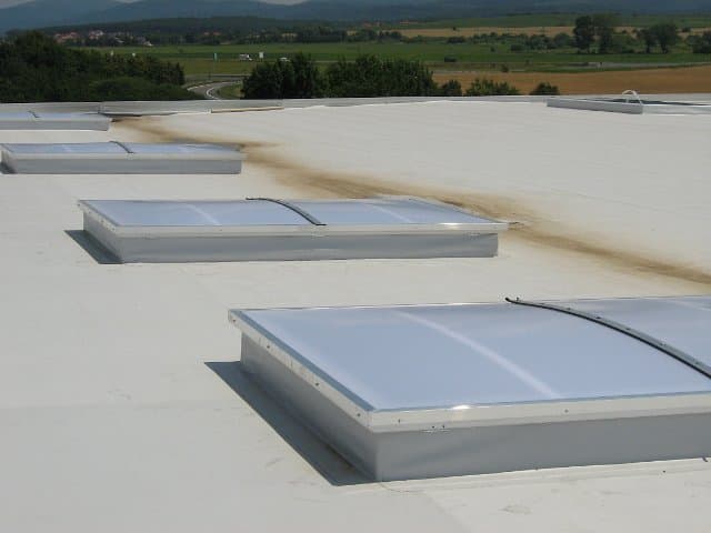 Smoke and heat extraction units fitted into a flat industrial roof