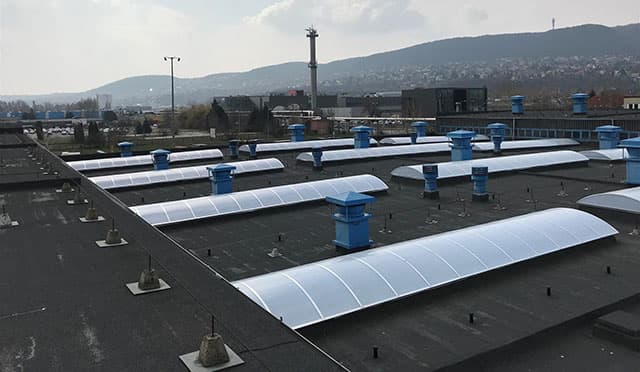 Finished arched rooflight ribbons across an industrial roof